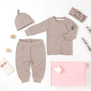 4 piece baby girl gift set in lavender.  The set includes a long sleeve top with matching pull on pants, a hat and a headband.  It is made from soft GOTS certified organic cotton.