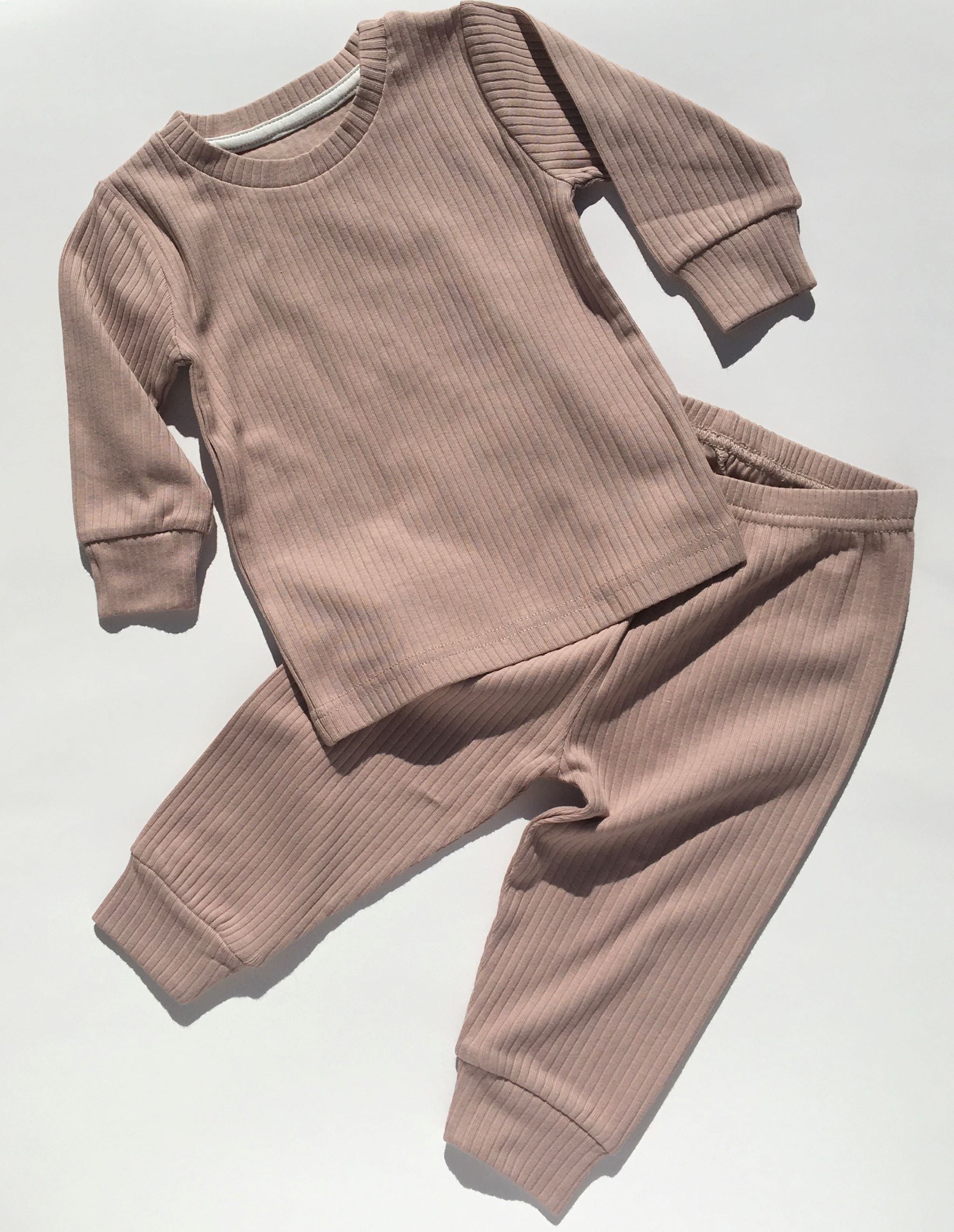 2 piece ribbed pajama set in lavender.  The set includes a long sleeve top and matching pull on pants,  It is made from soft, GOTS certified organic cotton.  